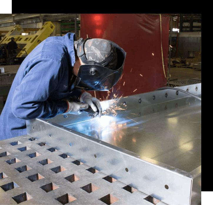 Worker Welding Steel Pipes