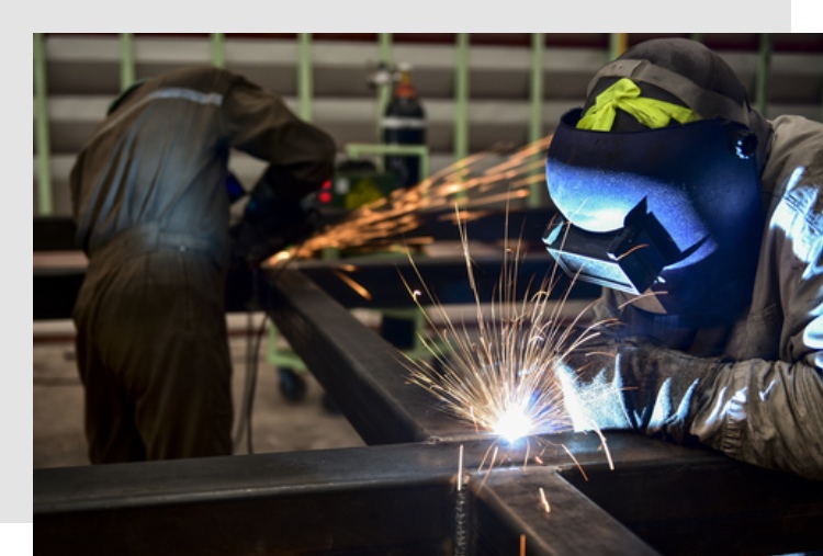 Sparks Fly as a Welders Working on Metal